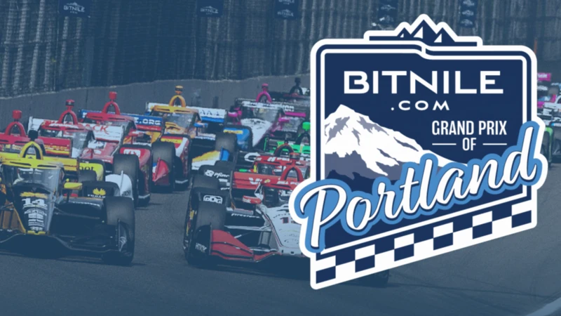 A photo of the Grand Prix Cars on the track with the Grand Prix of Portland Logo on the Right Side of the image.