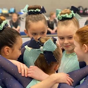 photo of gymnastics in a huddle before preformance