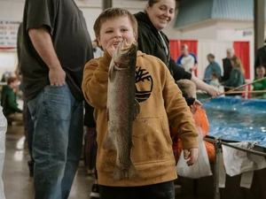 Kit with fish at trout pond at the Pacific Northwest Sportsmen Show