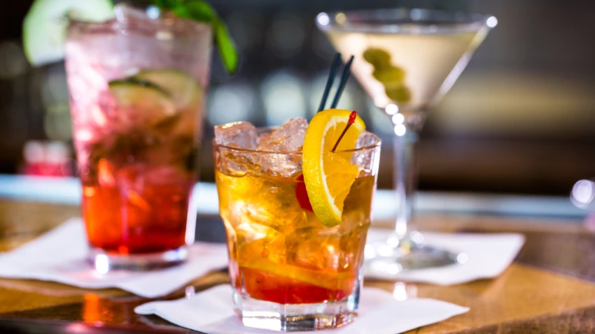 Three cocktails sitting on a table